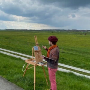 Een schilder maakt een schilderij in een landschap